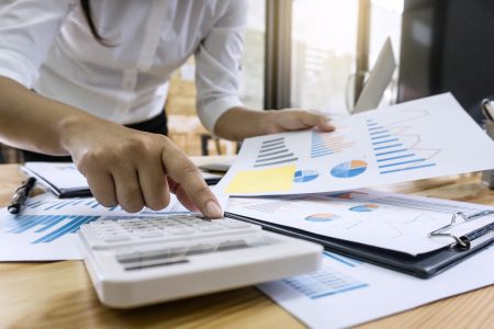 business-woman-accountant-working-and-calculating-financial-data-on-graph-documents.jpg